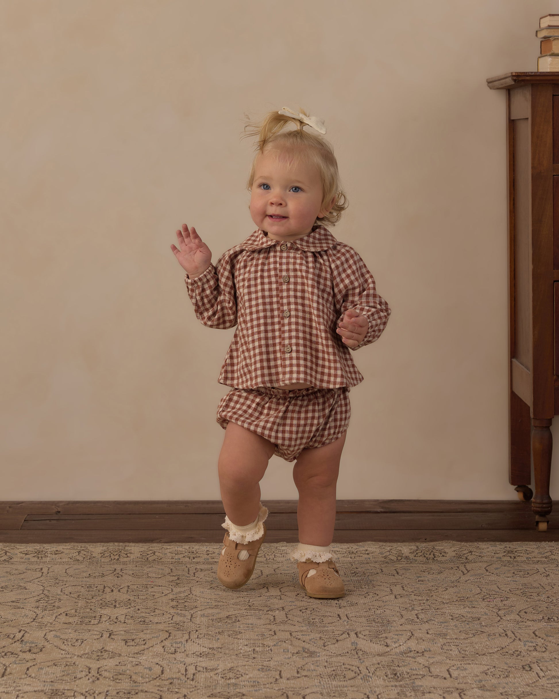 Toddler wearing the Rylee + Cru Nellie set in brick check gingham