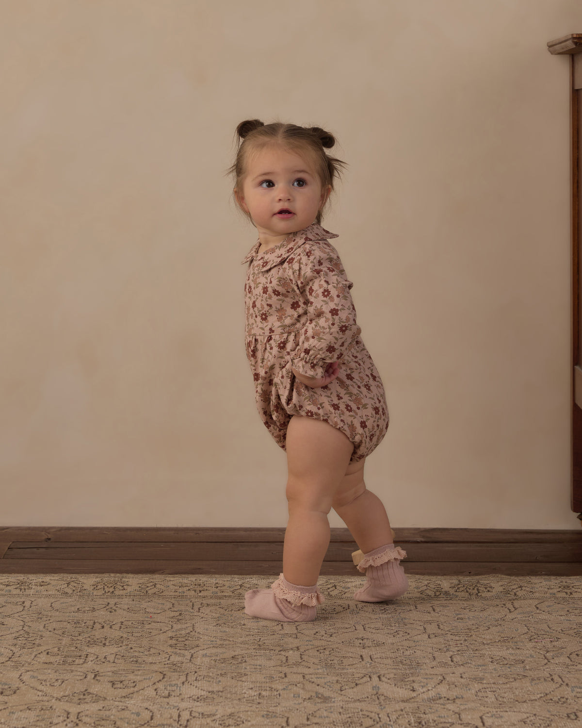 Toddler walking in the Rylee + Cru Cora romper in pink floral