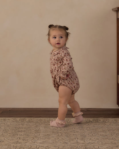 Toddler walking in the Rylee + Cru Cora romper in pink floral