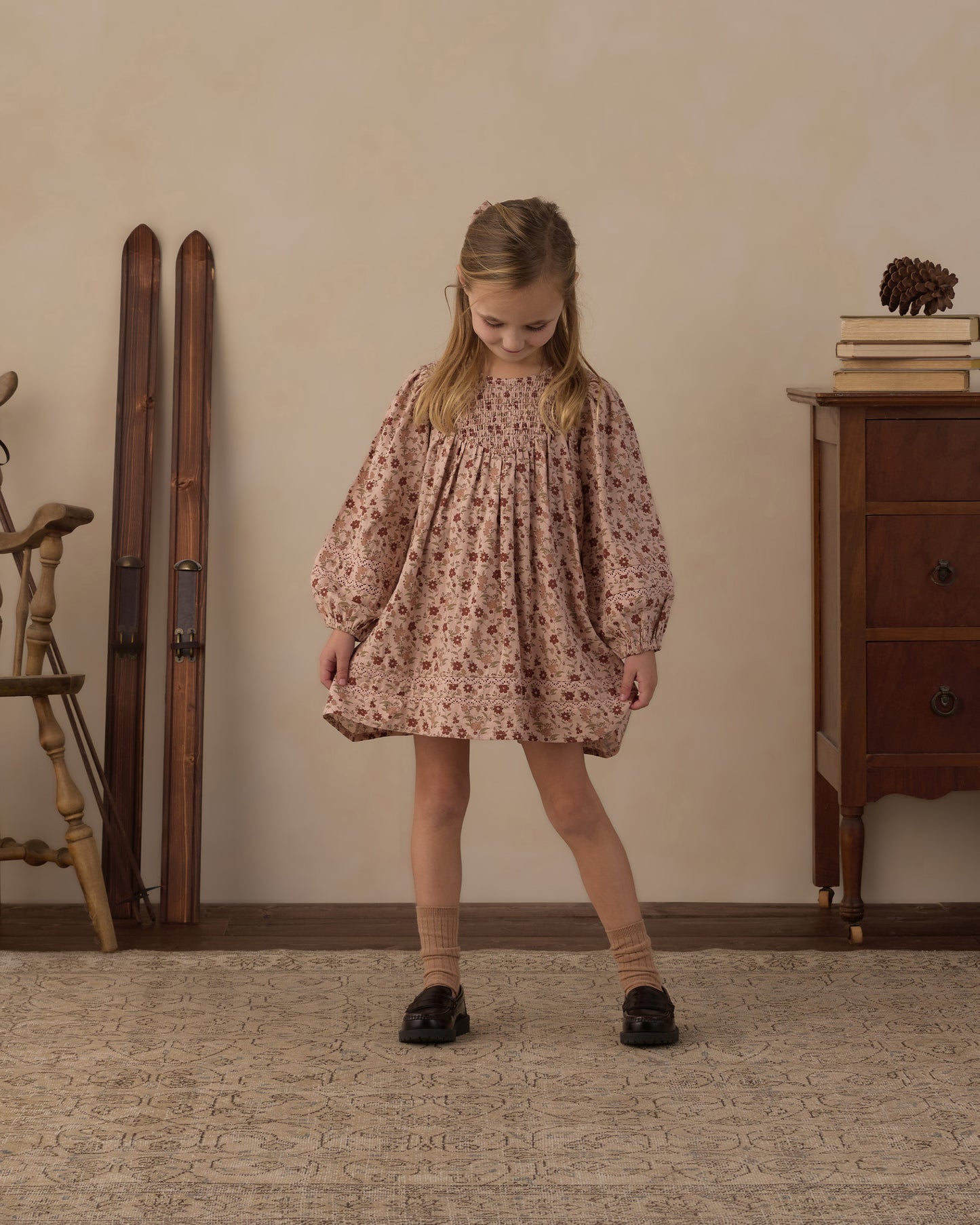 Girl standing in the Rylee + Cru Selene pink floral dress with black shoes