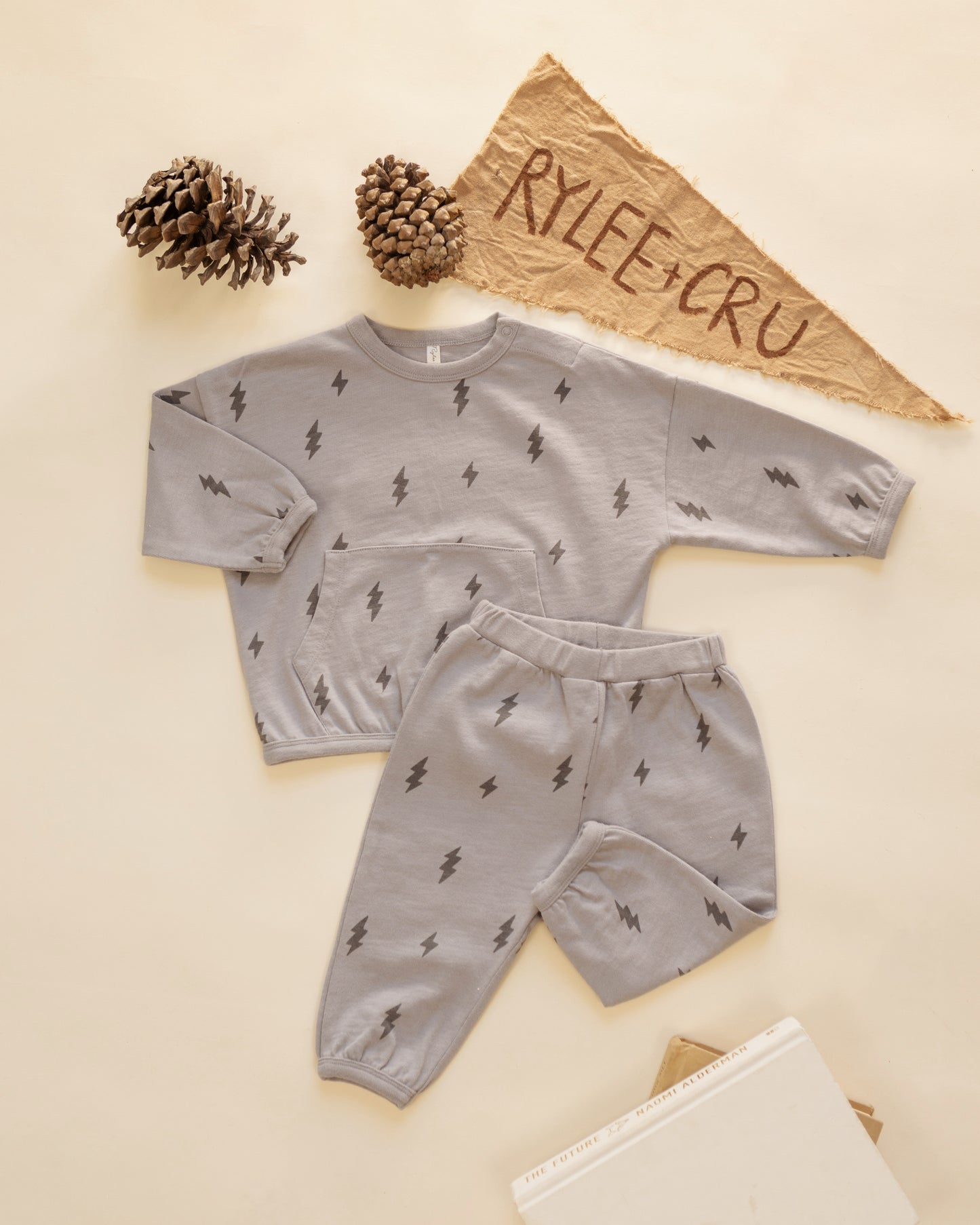Bolts relaxed set styled flat with pinecones and a Rylee + Cru felt pennant