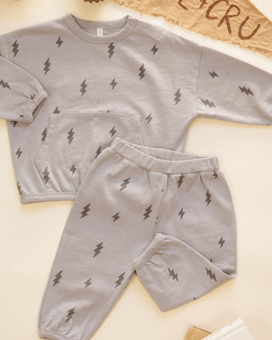 Rylee + Cru Relaxed Set in the Bolts print styled flat with a Rylee + Cru pennant and pinecones