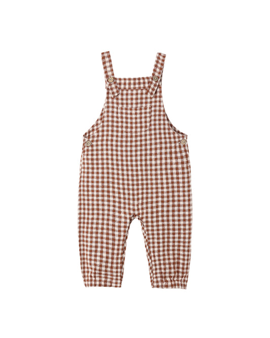 Rylee + Cru Baby Overalls in brick check gingham, laid flat with adjustable straps
