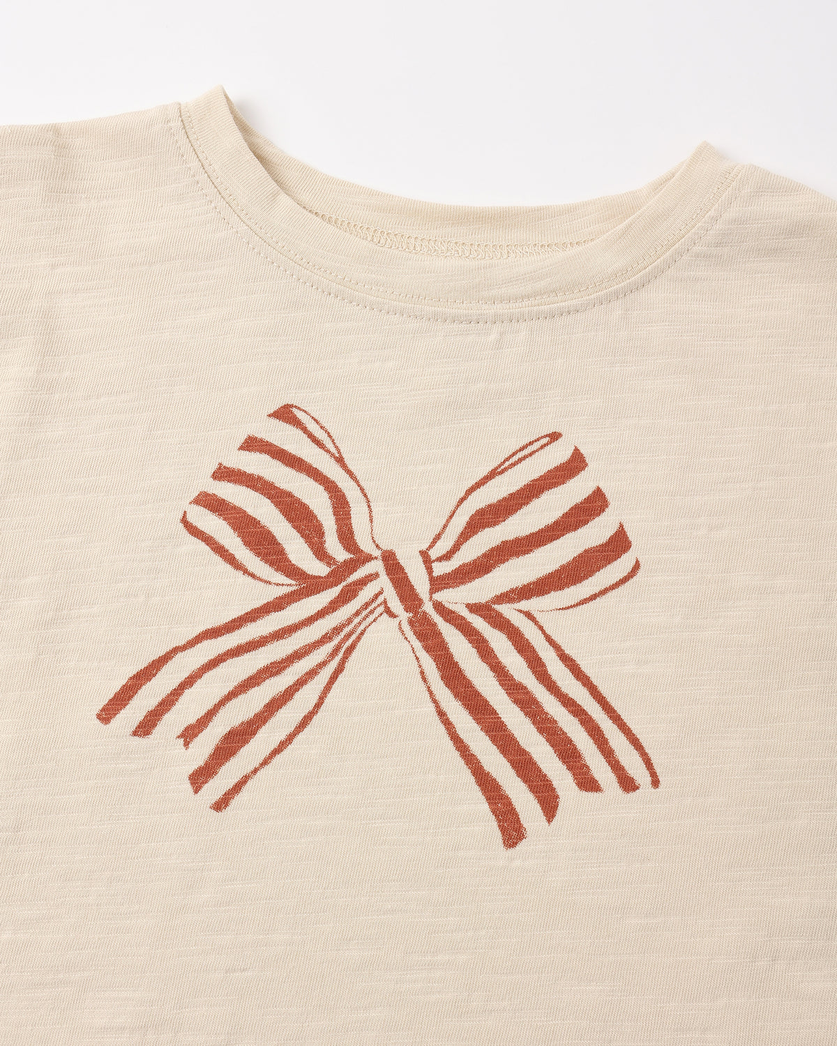 Close view of the red and white striped bow print on the Rylee + Cru ruffle long sleeve tee
