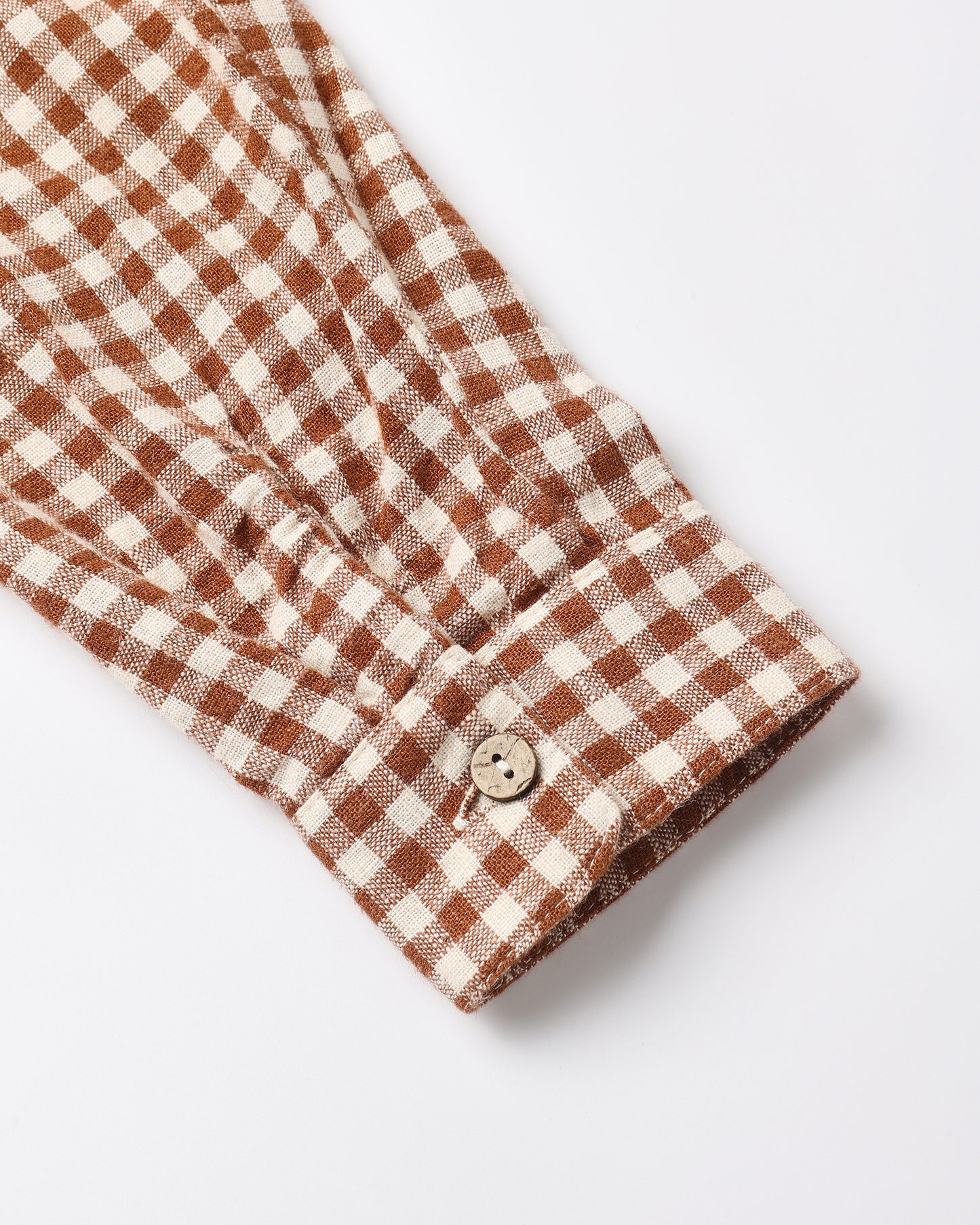 Close view of the brick check collared shirt cuff and button