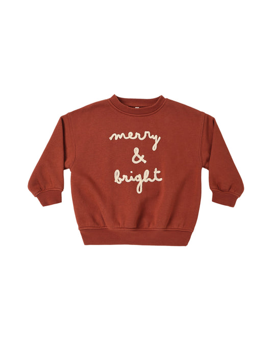 Rylee + Cru Merry & Bright relaxed sweatshirt in rust red with embroidered script, flat lay front view