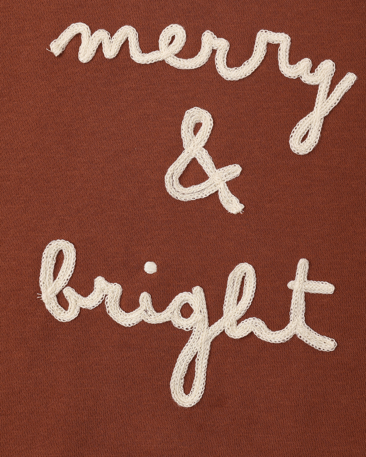 Close view of the embroidered merry & bright script on the Rylee + Cru relaxed sweatshirt