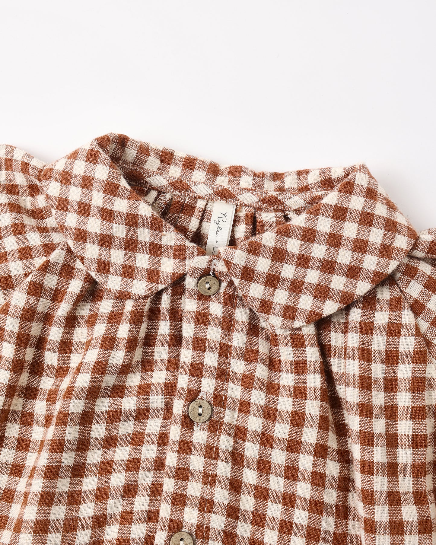 Close view of the Peter Pan collar and brick check fabric on the Nellie set top