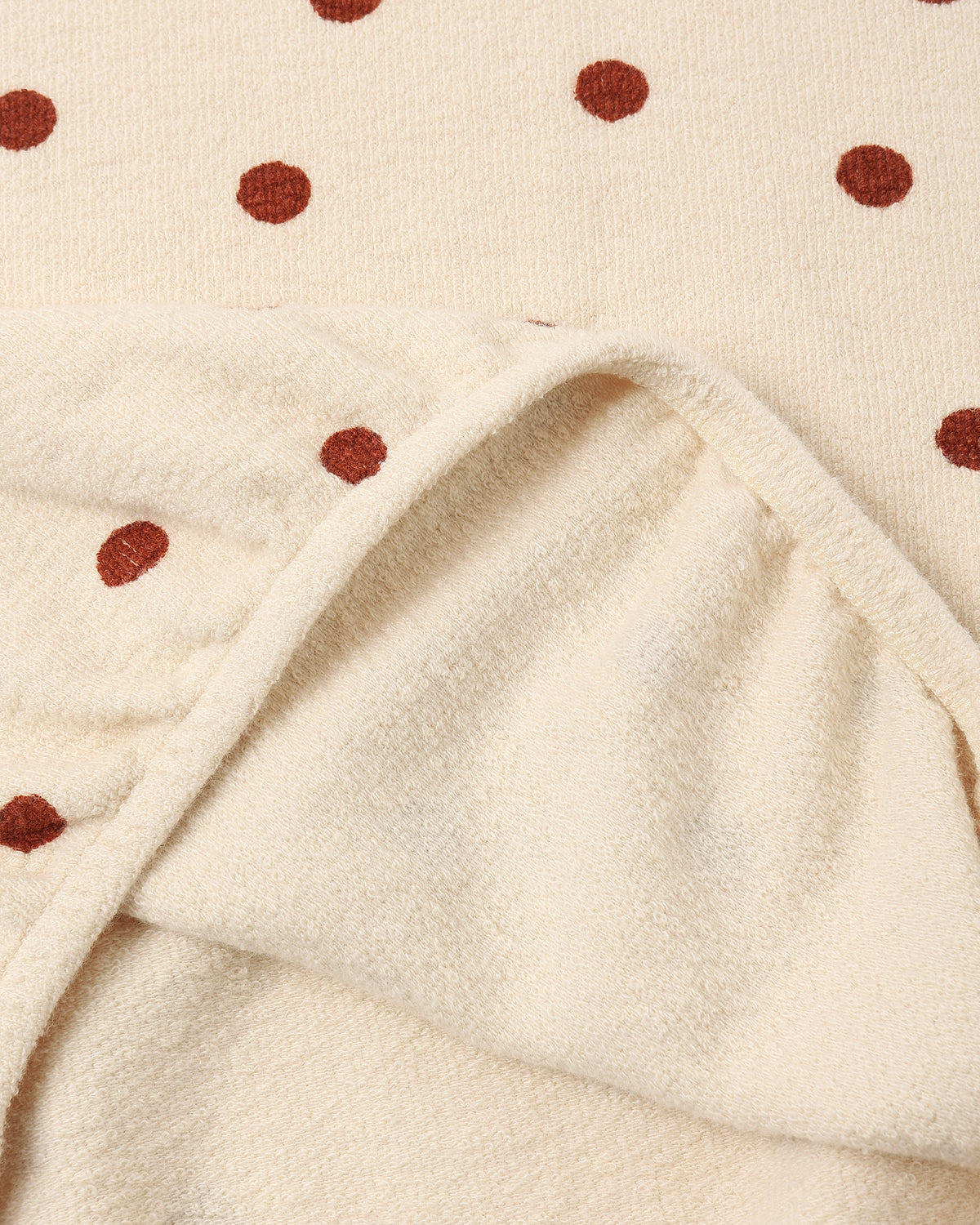 Fabric detail of the Rylee + Cru ruby dots spongey knit showing the soft looped inside