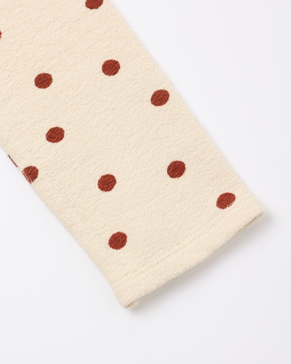 Close view of the ruby dot print and ribbed cuff on the Rylee + Cru spongey knit pants