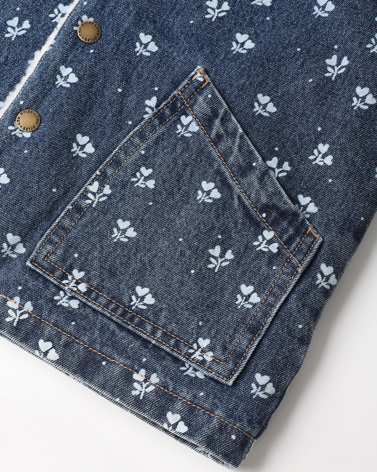 Close view of the Heart Ditsy indigo denim back pocket on the Rylee + Cru Long Chore Coat