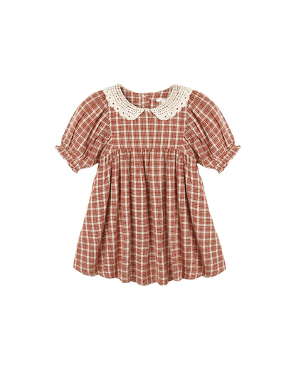 A toddler girl's short-sleeve dress with a ruby and white gingham pattern, featuring a cream-colored crochet Peter Pan collar and ruffled sleeves, shown against a plain white background.
