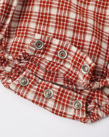 Close view of the snap closures and red plaid fabric on the Rylee + Cru Heidi romper