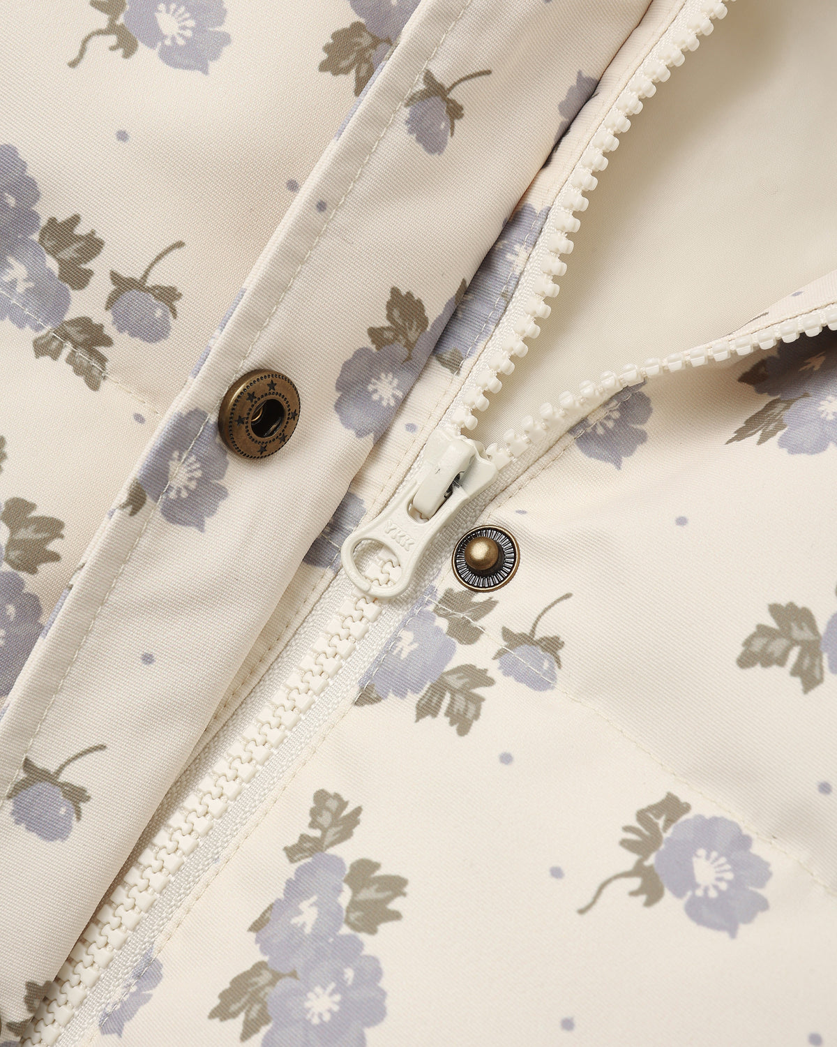 Detail of the Idyllwild Jacket placket with brass snaps and scalloped trim on the blue floral print