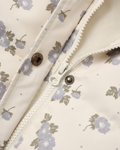 Detail of the Idyllwild Jacket placket with brass snaps and scalloped trim on the blue floral print