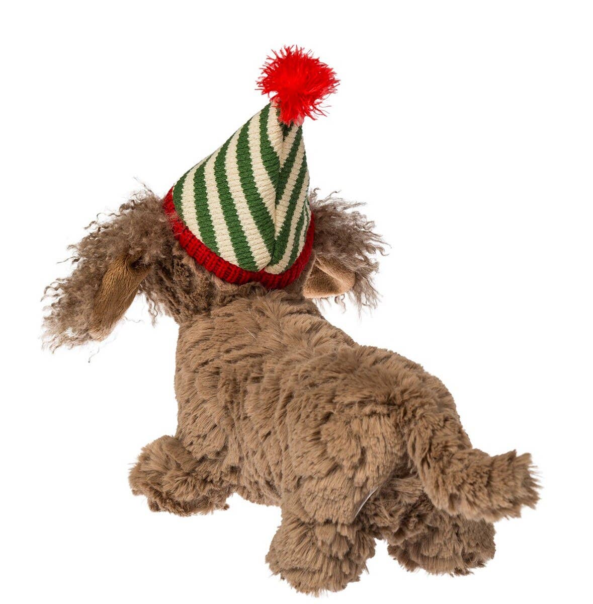 A brown curly-haired dog wearing a festive knit pointed hat with green and cream stripes and a red pom-pom, shown against a plain white background.