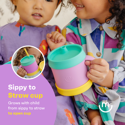 Two children holding a purple and green sippy to straw cup with an inset showing its use.