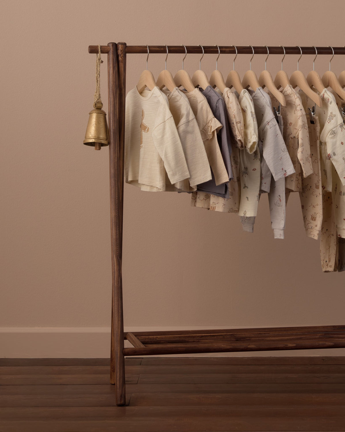 Wooden clothing rack hung with pieces from the Rylee + Cru holiday collection