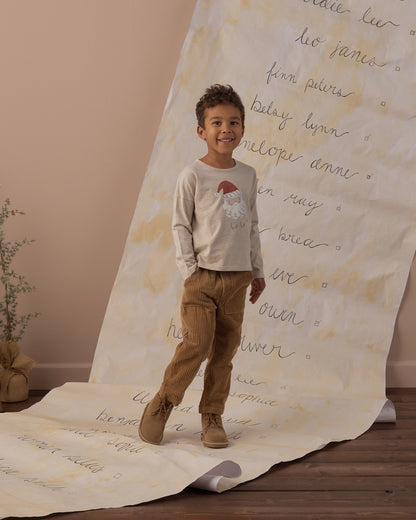 Boy mid-step in the Rylee + Cru Santa long sleeve tee, full-length view with tan pants and boots