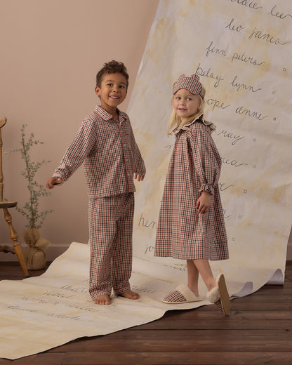 Boy and girl laughing in matching Rylee + Cru holiday gingham pajamas, full-length view