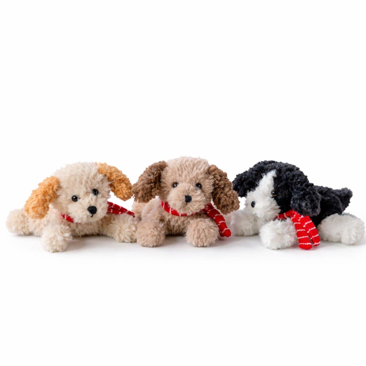 Three plush puppy toys lined up on a white background, each with curly fur in different colors and wearing red striped scarves.