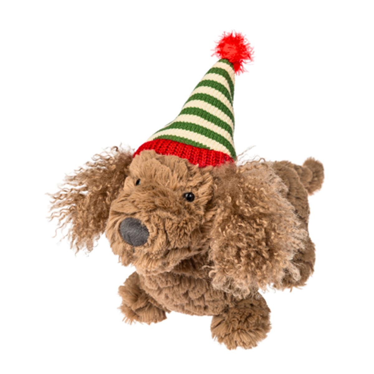 A brown curly-haired plush dog toy wearing a green and cream striped knit elf hat with a red band and red pom-pom, isolated on a white background.