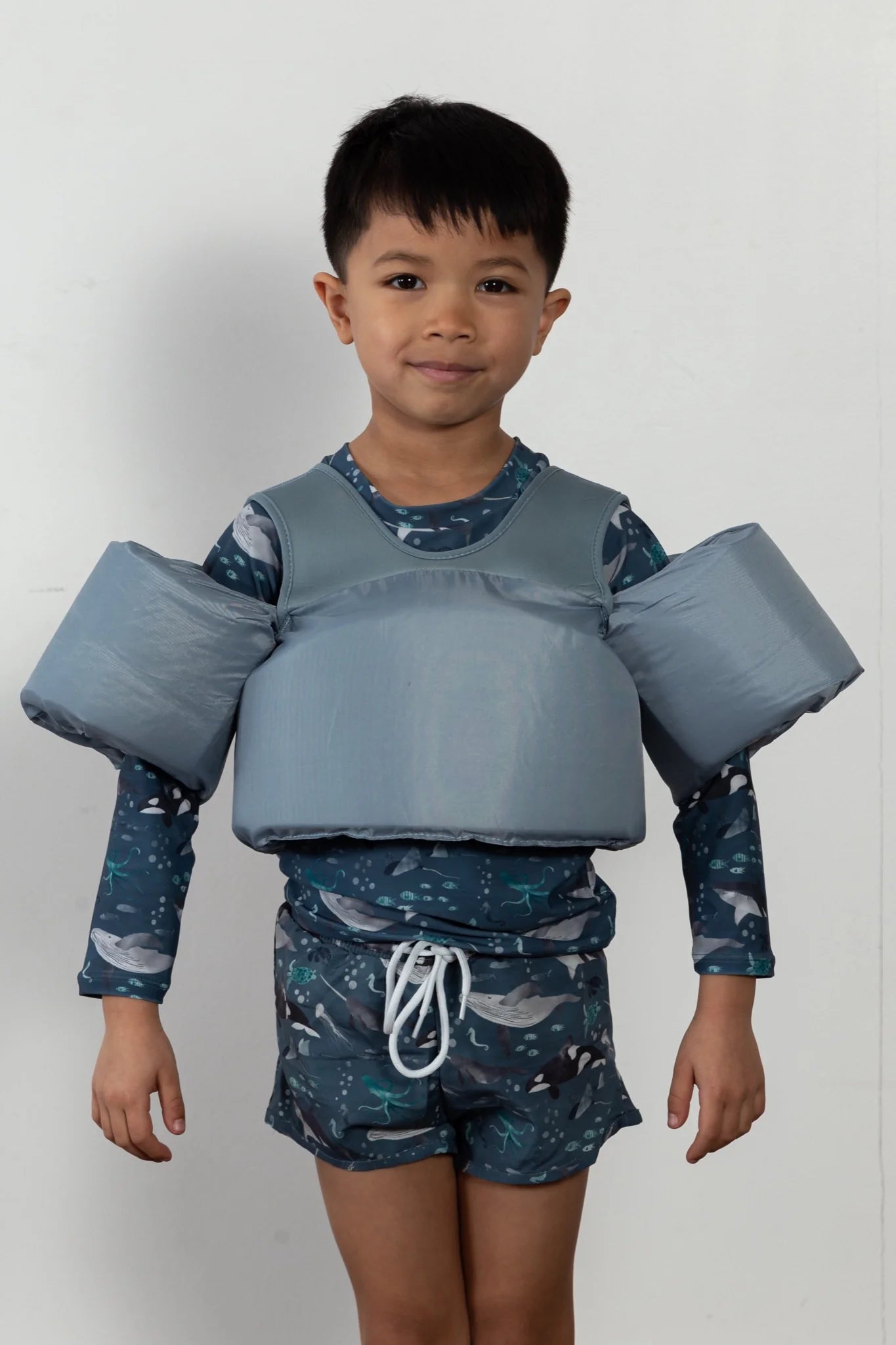 Boy wearing Stone Blue Water Wing Floaties