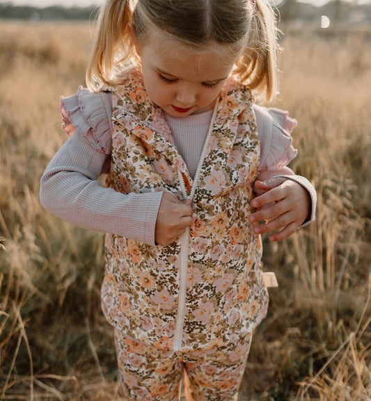 girl zipping up her florence sherpa lined hooded vest