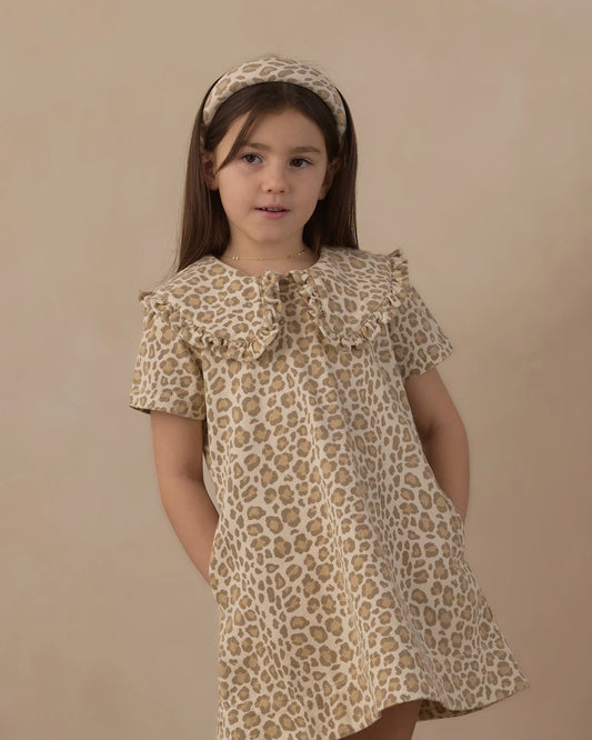 Girl with a headband wearing the Rylee + Cru collared denim mini dress in leopard print, front view