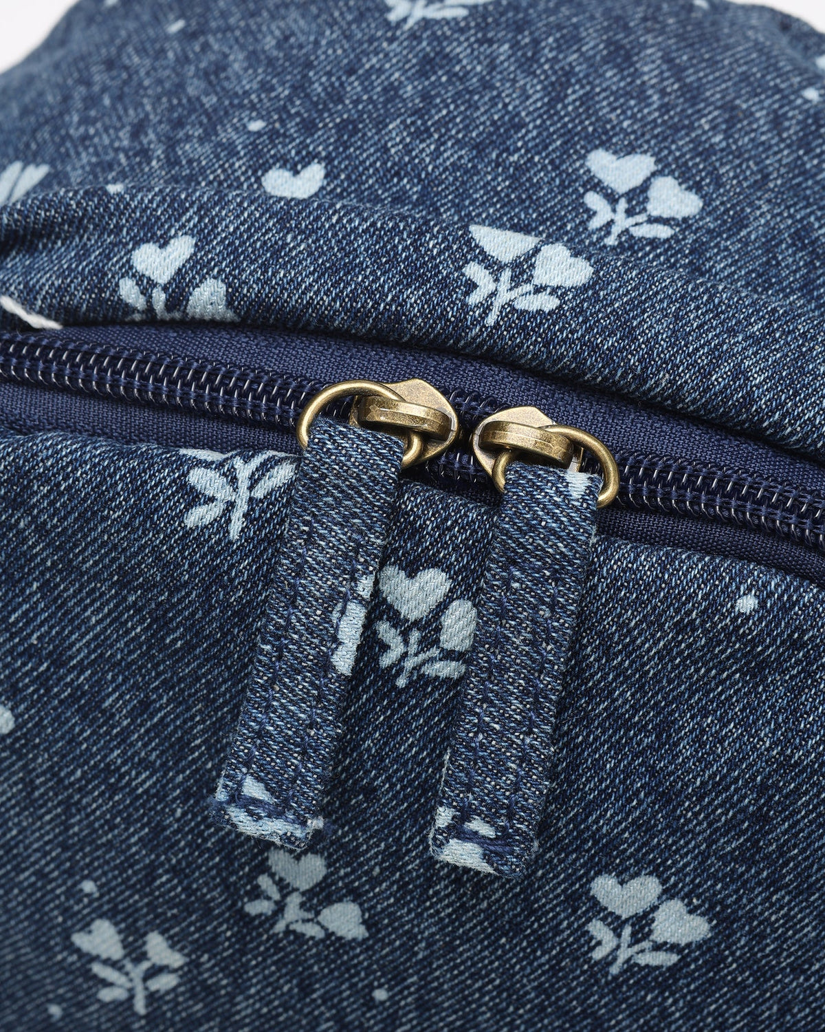 Detail view of the Rylee + Cru Heart Ditsy Mini Backpack showing the zippered compartment, front pocket and adjustable straps