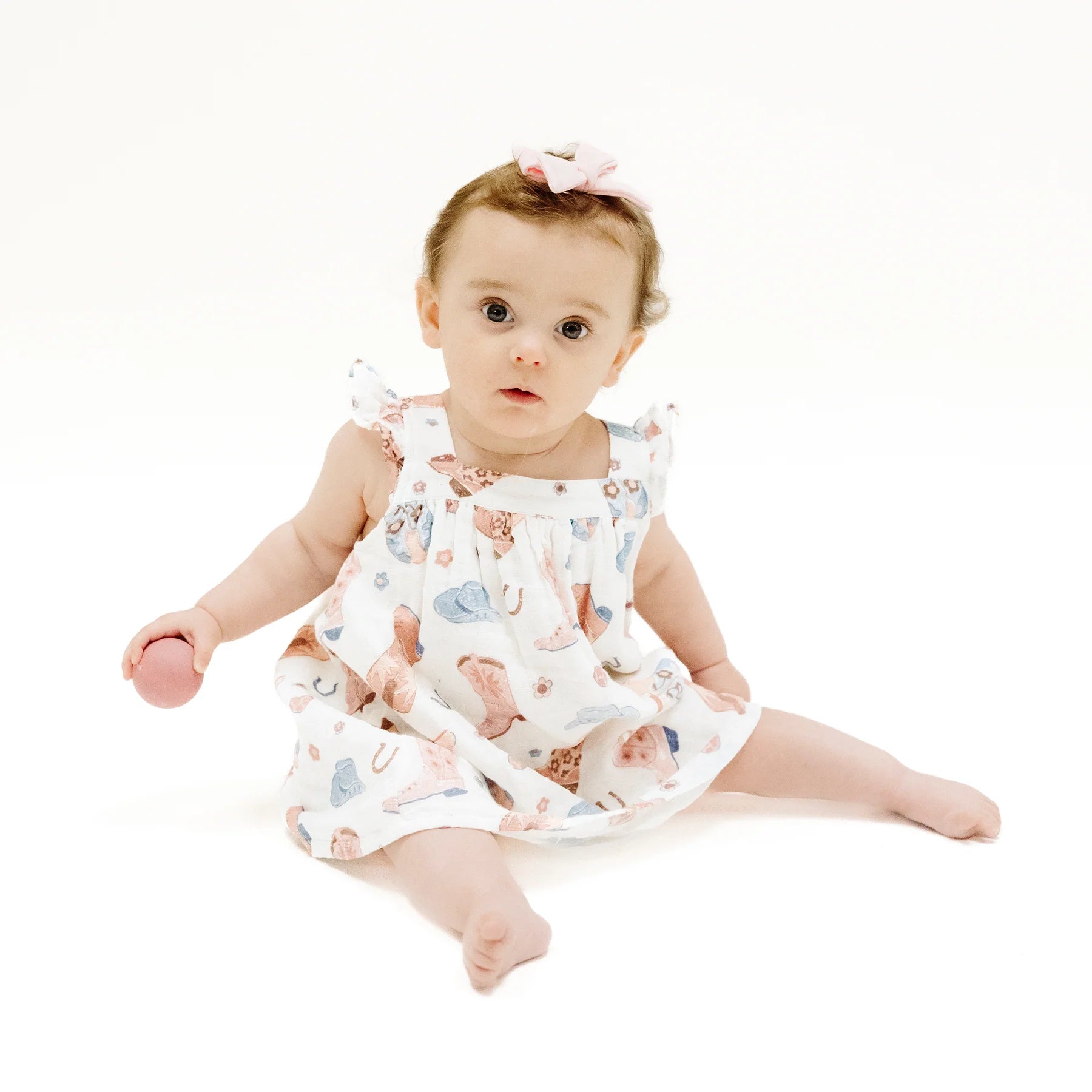 Little girl wearing our organic cotton muslin Cowboy Boots Pink Sundress