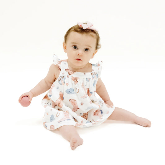Little girl wearing our organic cotton muslin Cowboy Boots Pink Sundress